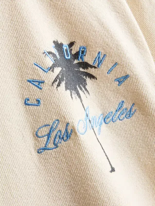 7–15 år | T-shirt med palmmotiv och struktur