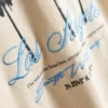 7–15 år | T-shirt med palmmotiv och struktur