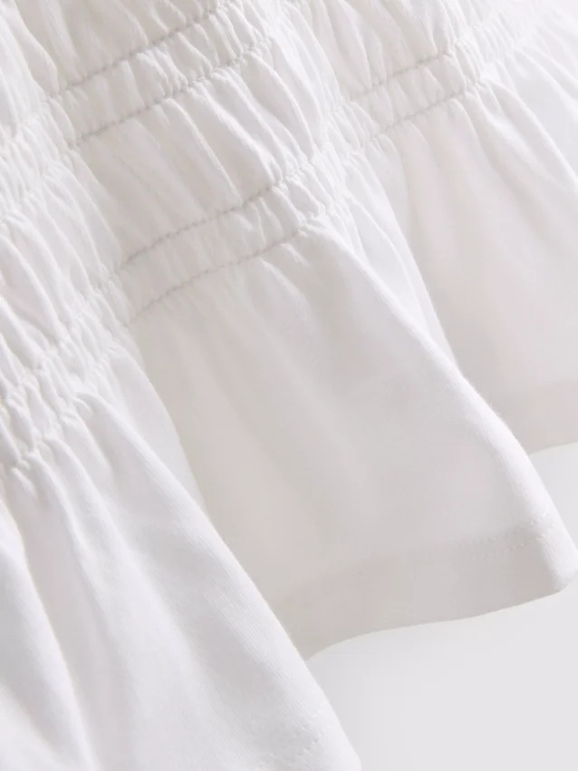 7–15 år | T-shirt med rynkad peplum