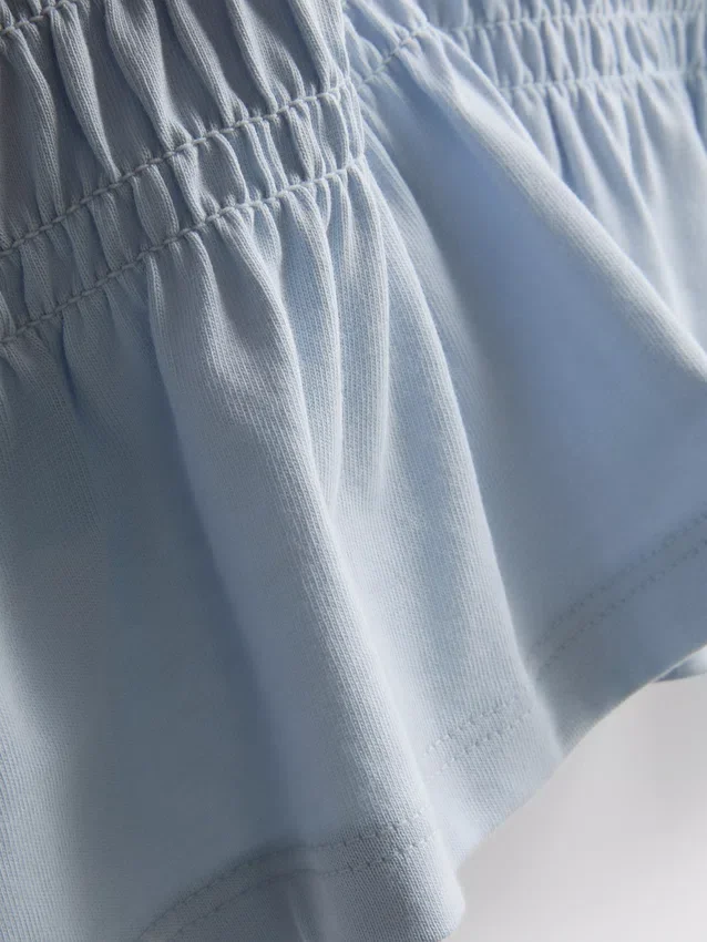 7–15 år | T-shirt med rynkad peplum
