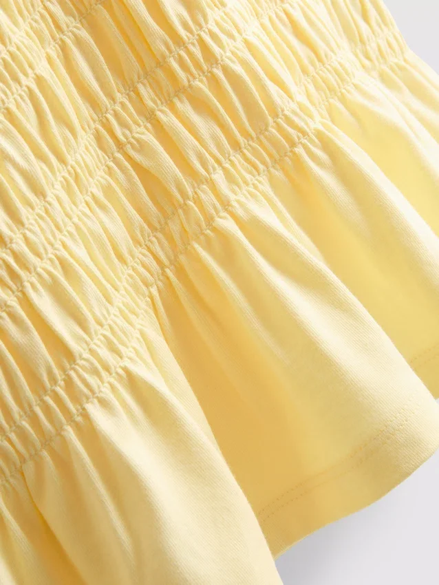 7–15 år | T-shirt med rynkad peplum