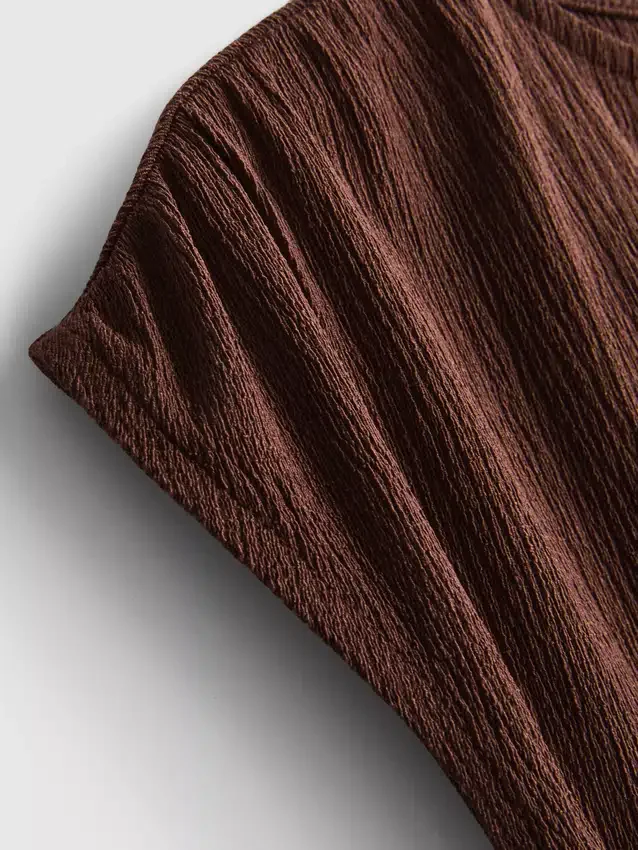 Asymmetrisk skrynklig topp