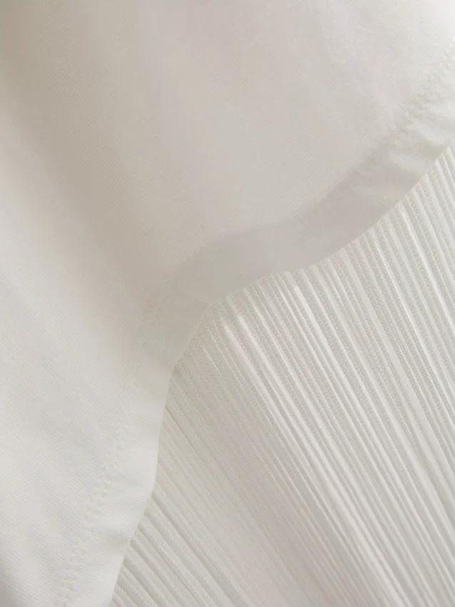 Asymmetrisk T-shirt i bomull med fransar