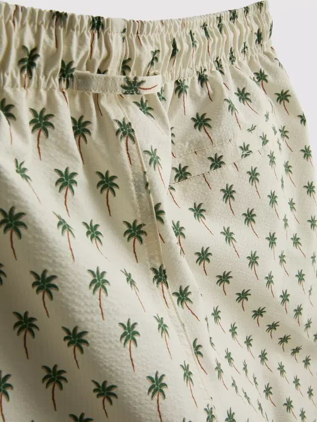 Badshorts med palmträdsmönster