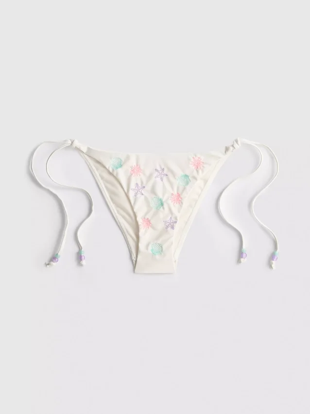 Bikinibottnar med broderat yttertyg och knytband i sidan