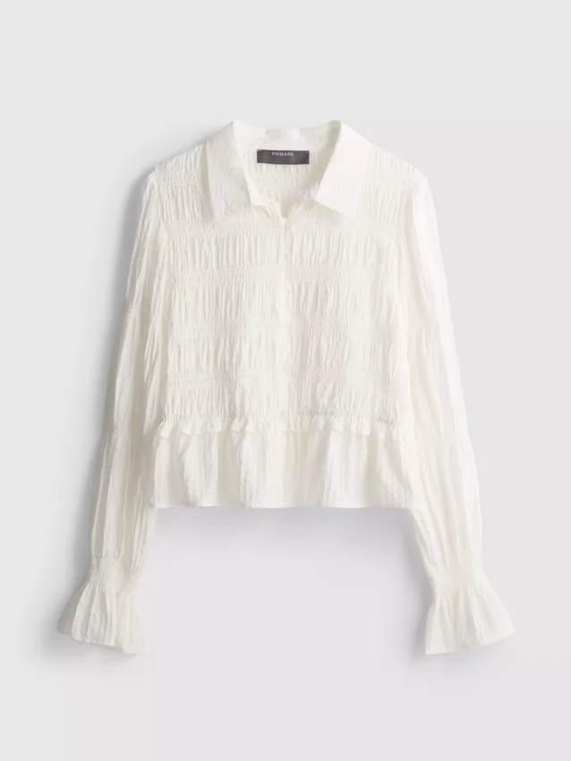 Blus med rynkad peplum-nedkant