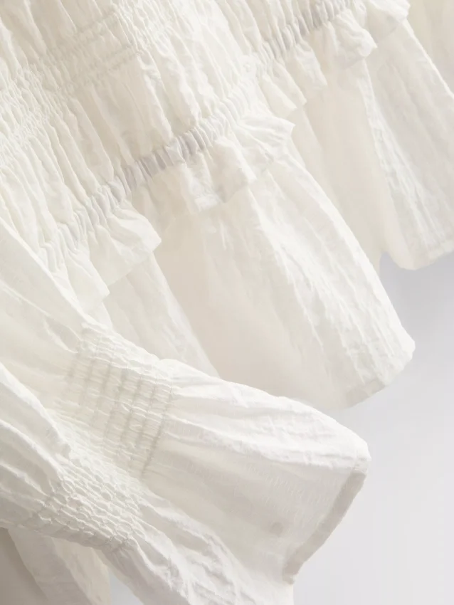 Blus med rynkad peplum-nedkant