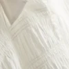 Blus med rynkad peplum-nedkant