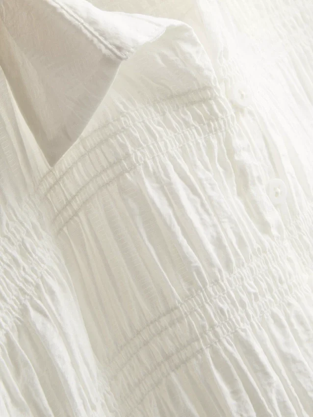 Blus med rynkad peplum-nedkant