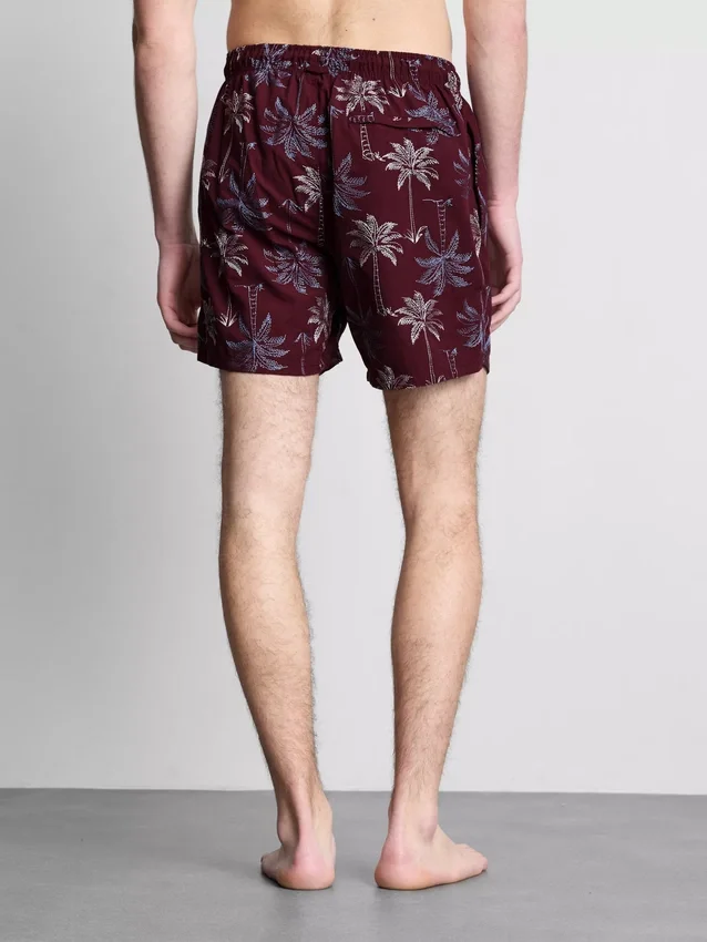 Broderade badshorts med palmträd