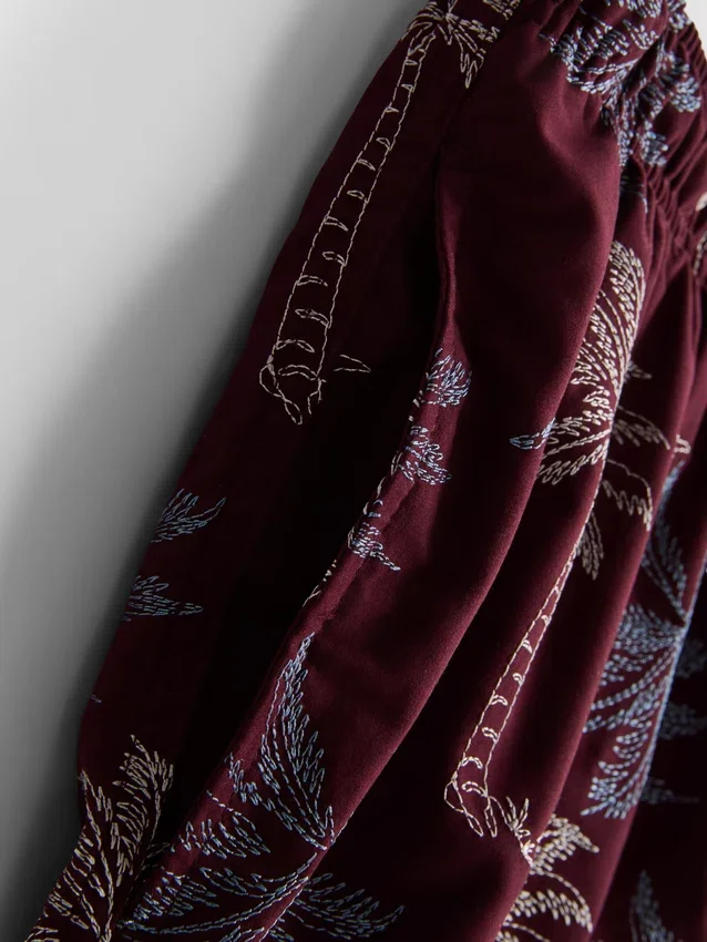 Broderade badshorts med palmträd
