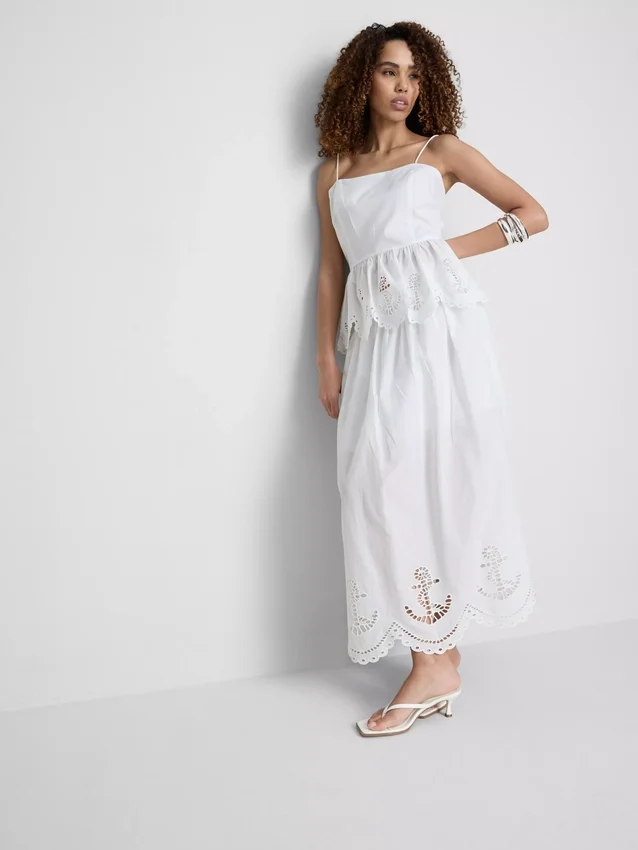 Cami-top i bomull med broderad peplum-kant
