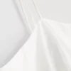 Cami-top i bomull med broderad peplum-kant