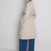 Oumbärlig trenchcoat med bälte