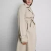 Oumbärlig trenchcoat med bälte