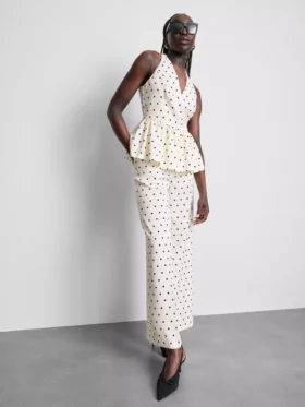 Peplum-top med halterneck och prickmönster