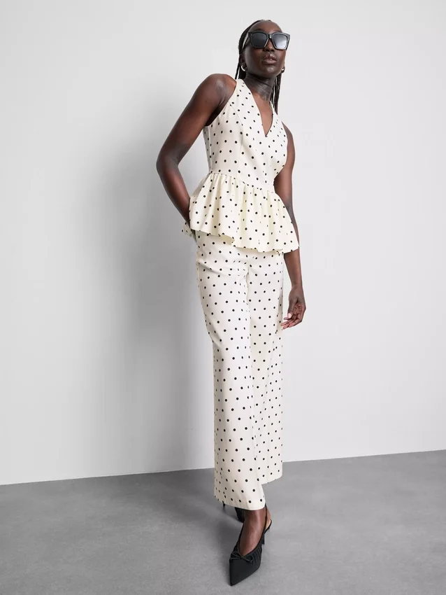 Peplum-top med halterneck och prickmönster