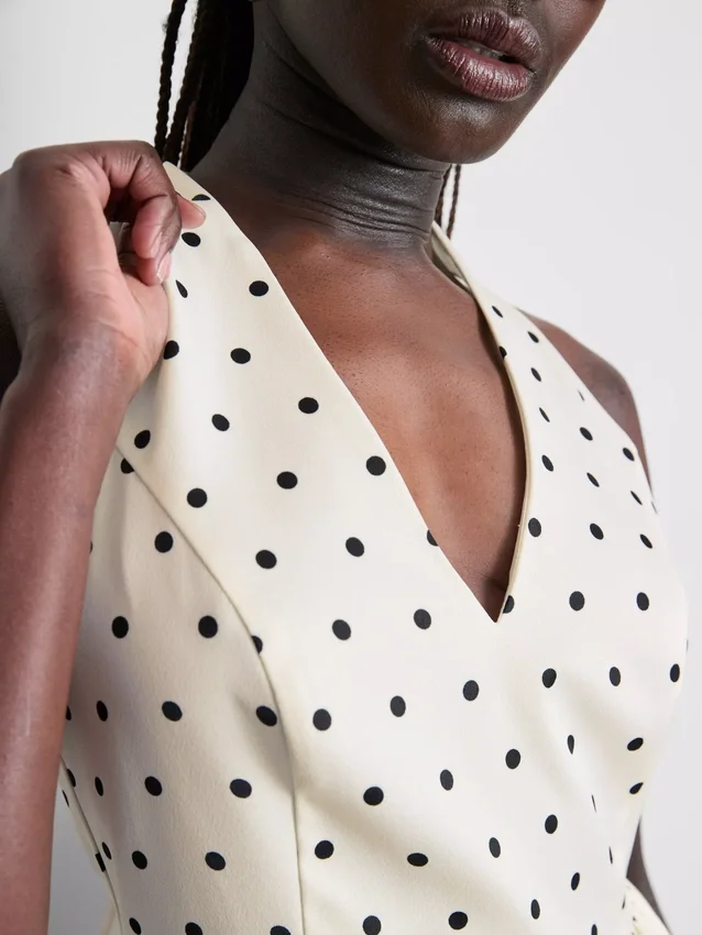 Peplum-top med halterneck och prickmönster