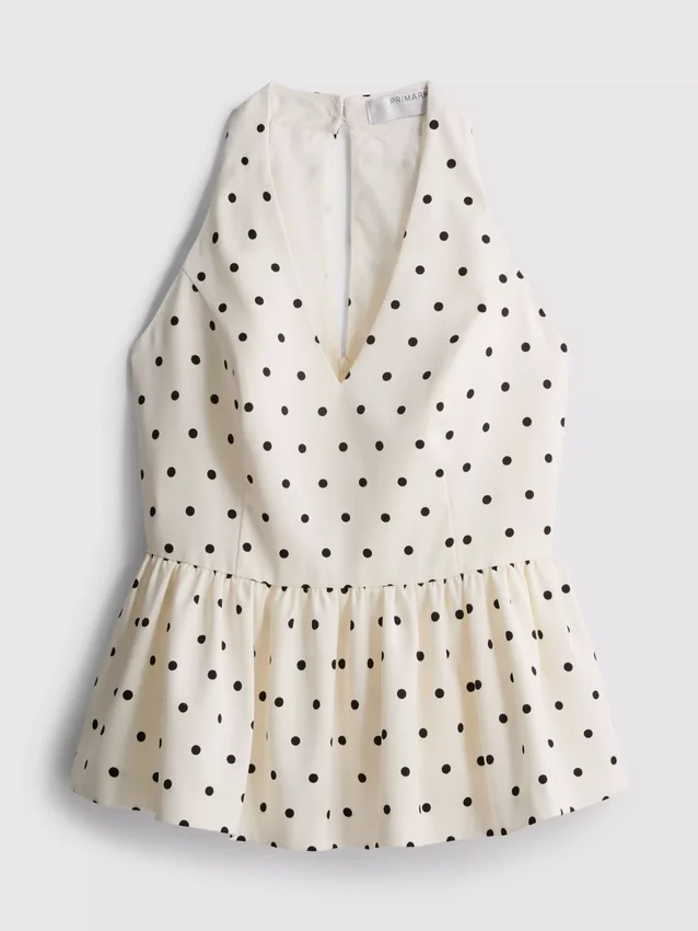Peplum-top med halterneck och prickmönster
