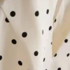 Peplum-top med halterneck och prickmönster