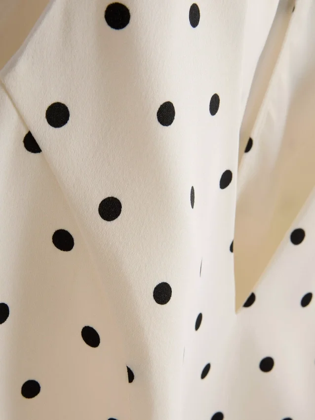 Peplum-top med halterneck och prickmönster