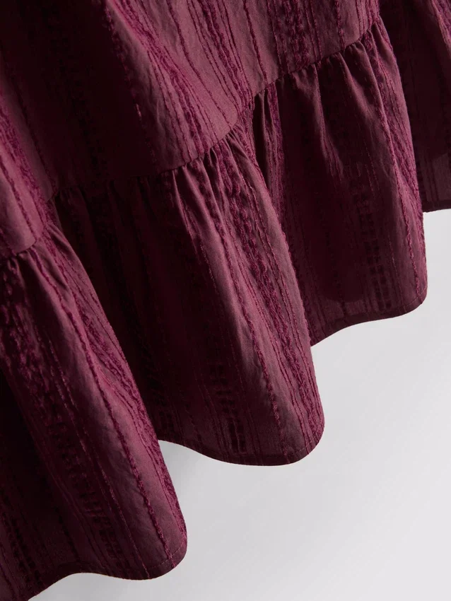 Randig linne med peplum-kant