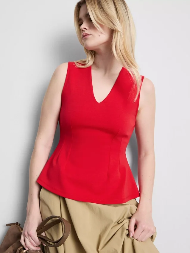 Ärmlös topp med V-ringning och peplum